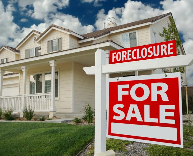Foreclosure Home For Sale Sign in Front of New House Foreclosure Home For Sale Sign in Front of New House
